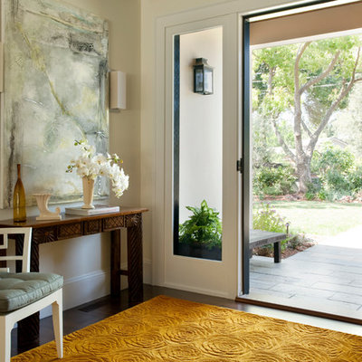 Example of a large transitional dark wood floor and brown floor entryway design in San Francisco with beige walls and a medium wood front door