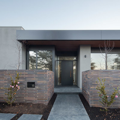 Example of a trendy gray floor entryway design in Canberra - Queanbeyan with a black front door