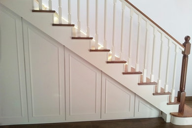 Idée de décoration pour un escalier peint de taille moyenne avec des marches en bois et un garde-corps en bois.