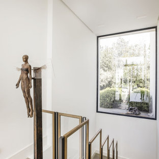 Imagen de escalera en U, contemporánea, con escalones de madera, contrahuellas de madera y barandilla de varios materiales