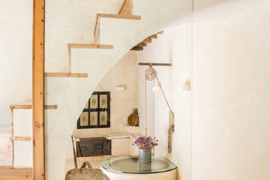 Inspiration for a mediterranean wood straight staircase in Other with wood risers.
