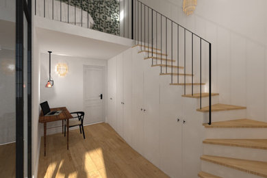 Exemple d'un escalier moderne en L de taille moyenne avec des marches en bois, des contremarches en bois, un garde-corps en métal et du papier peint.