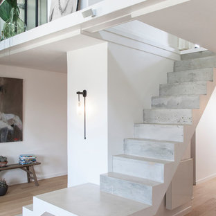 Exemple d'un escalier tendance avec des marches en béton et des contremarches en béton.