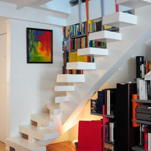 Idée de décoration pour un escalier courbe design de taille moyenne avec des marches en béton et des rangements.