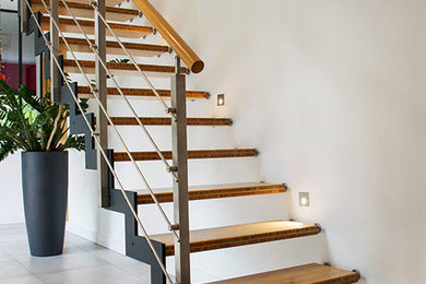 Foto de escalera recta industrial con escalones de madera