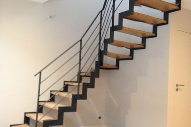Imagen de escalera en L contemporánea de tamaño medio con escalones de madera