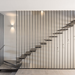 Cette image montre un escalier sans contremarche flottant design.