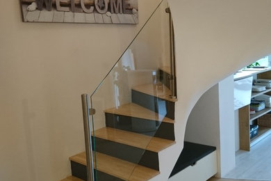 This is an example of a modern staircase in Angers with feature lighting.