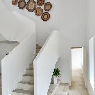 Idées déco pour un escalier exotique en L de taille moyenne avec des marches en béton et des contremarches en béton.
