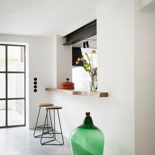 Offenes, Kleines Industrial Esszimmer ohne Kamin mit weißer Wandfarbe, Betonboden und grauem Boden in München