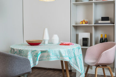 Photo of a small scandinavian dining room in Berlin with white walls and dark hardwood flooring.