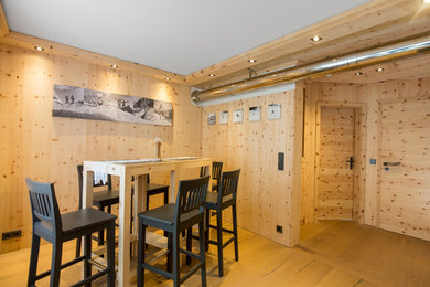 Foto de comedor campestre de tamaño medio cerrado sin chimenea con paredes beige, suelo de madera clara y suelo marrón