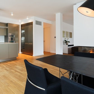 Exempel på ett stort modernt kök med matplats, med vita väggar, mellanmörkt trägolv, en bred öppen spis, en spiselkrans i gips och beiget golv