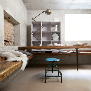Dining room - industrial concrete floor dining room idea in Munich with gray walls