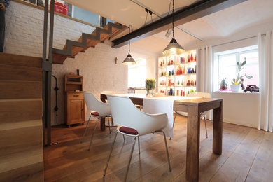 Photo of a contemporary dining room in Frankfurt with medium hardwood flooring.