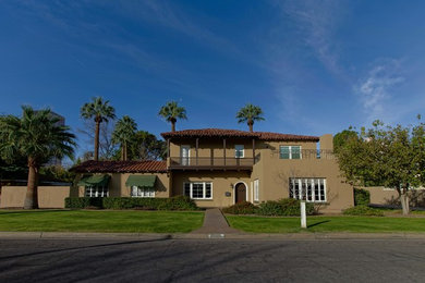 Huge elegant brown two-story house exterior photo in Phoenix with a tile roof