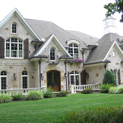 Inspiration for a huge craftsman beige two-story mixed siding exterior home remodel in Boston with a tile roof