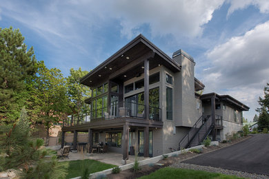 Example of a trendy brown two-story mixed siding exterior home design in Boise with a mixed material roof
