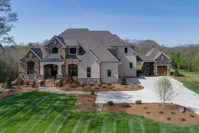 Example of a huge arts and crafts two-story house exterior design in Charlotte