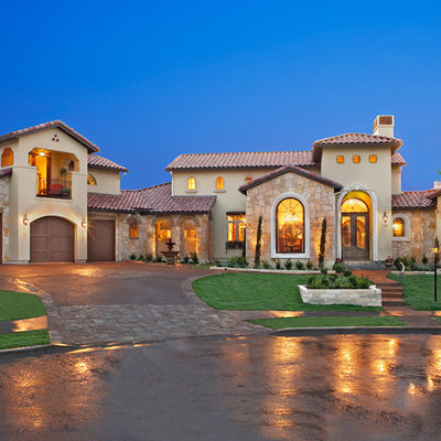 Inspiration for a mediterranean two-story exterior home remodel in Austin