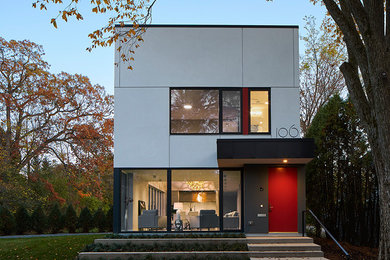 Foto de fachada de casa gris contemporánea de tamaño medio de dos plantas con revestimientos combinados y tejado plano