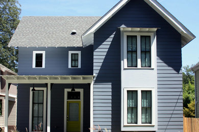 Example of a mid-sized farmhouse blue two-story wood gable roof design in Atlanta