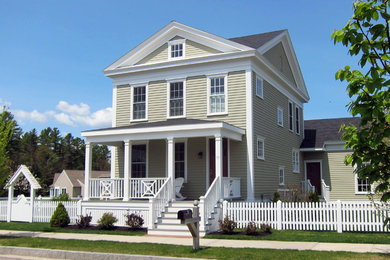 Photo of a beige traditional two floor house exterior in Portland Maine with wood cladding and a pitched roof.