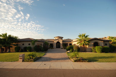 Inspiration for a large mediterranean beige one-story stucco exterior home remodel in Phoenix