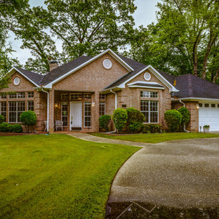 Example of a large classic red one-story brick exterior home design in Austin