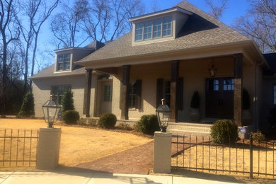 Inspiration for a large timeless beige three-story brick exterior home remodel in Birmingham