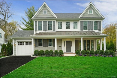Inspiration for a mid-sized transitional gray two-story mixed siding exterior home remodel in New York with a metal roof