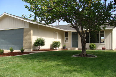 Photo of a medium sized and gey classic bungalow house exterior in Boise with wood cladding and a pitched roof.
