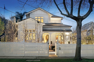 White traditional two floor house exterior in Melbourne with wood cladding.