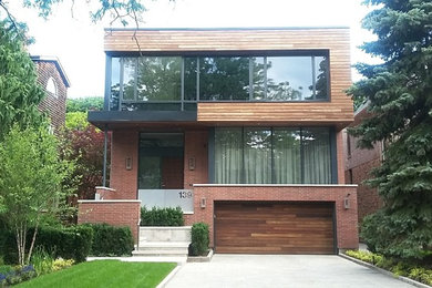 Mid-sized tuscan wood house exterior photo in Toronto