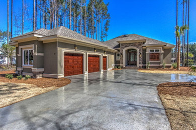 Tuscan one-story stucco exterior home photo in Atlanta with a hip roof