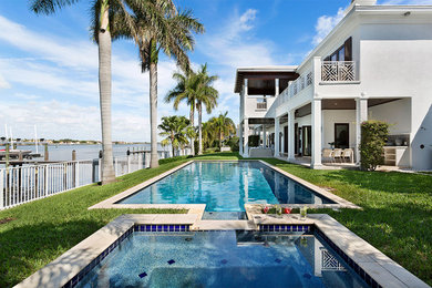 Large white two-story house exterior idea in Miami with a tile roof