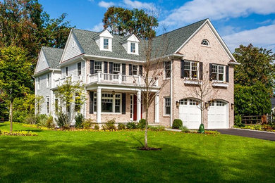 Large traditional white two-story vinyl exterior home idea in New York with a clipped gable roof
