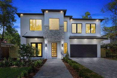 Inspiration for a contemporary white two-story house exterior remodel in Orlando