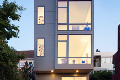 Gey contemporary house exterior in Seattle with three floors.