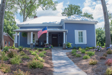 Example of a small classic blue one-story concrete fiberboard house exterior design in Atlanta with a hip roof and a metal roof
