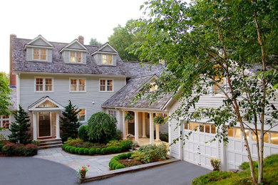 Large transitional beige three-story wood gable roof photo in New York