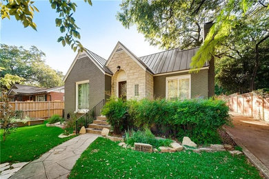 Inspiration for a timeless green one-story brick exterior home remodel in Dallas with a metal roof