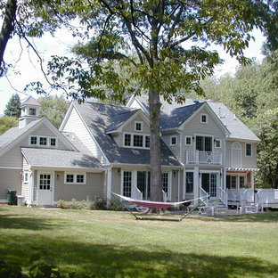 Large traditional gray two-story wood gable roof idea in New York