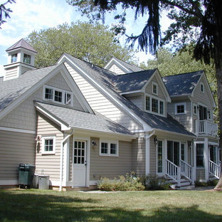 Example of a large classic gray two-story wood gable roof design in New York