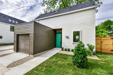Small minimalist white two-story concrete fiberboard exterior home photo in Austin with a shingle roof
