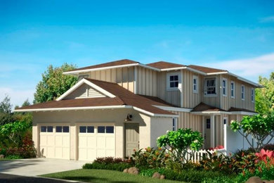 Example of a large beige two-story exterior home design in Hawaii