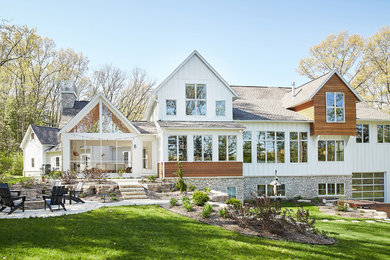 Example of a cottage white three-story house exterior design