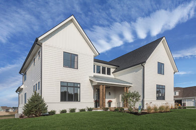 Large country white two-story concrete fiberboard house exterior photo in Indianapolis with a mixed material roof