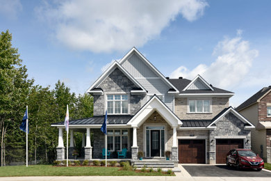 Foto de fachada de casa gris tradicional renovada extra grande de dos plantas con revestimientos combinados