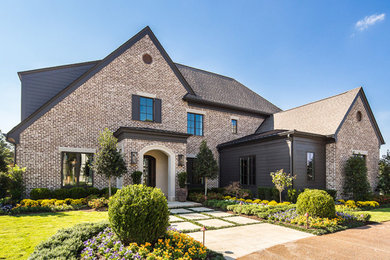 Photo of a traditional two floor brick detached house in Other with a shingle roof.